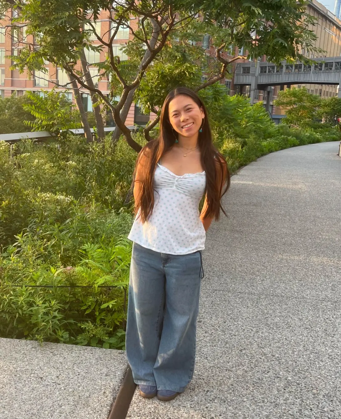 Megan Pan standing on a garden walkway
