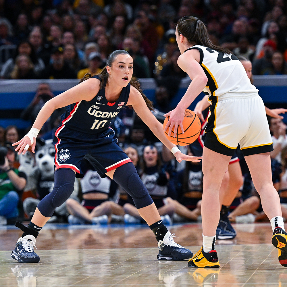Two basketball players facing each other during a game