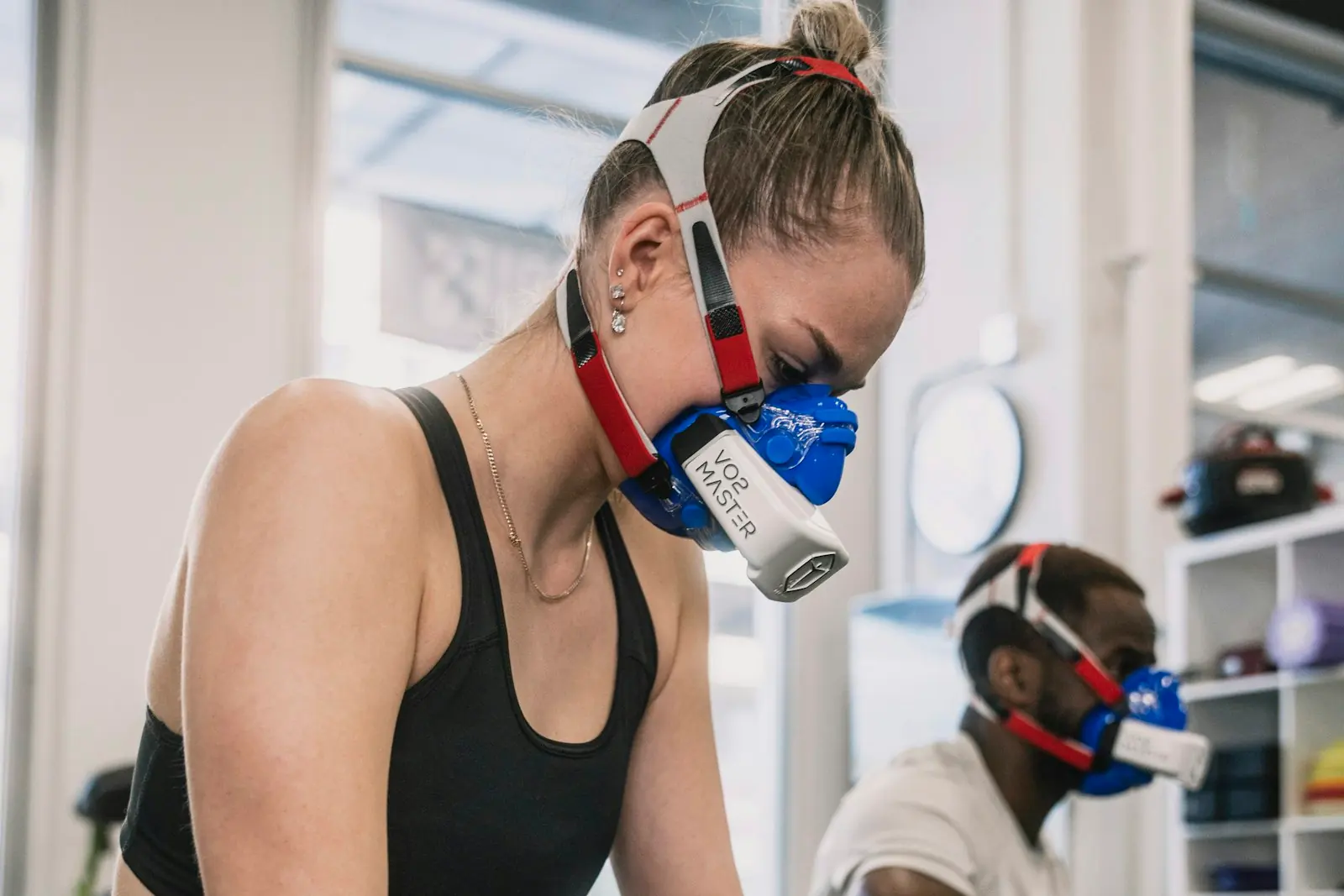 An athlete on a stationary bike wears a breathing mask during a sports science fitness test