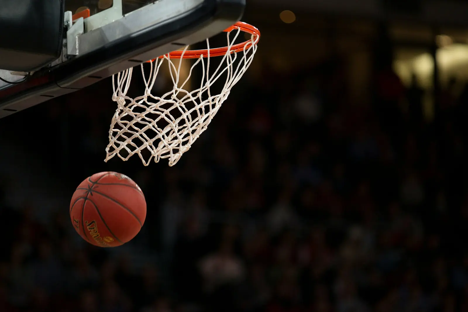 A basketball dropping through the hoop